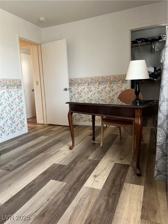 office featuring baseboards, wallpapered walls, and wood finished floors