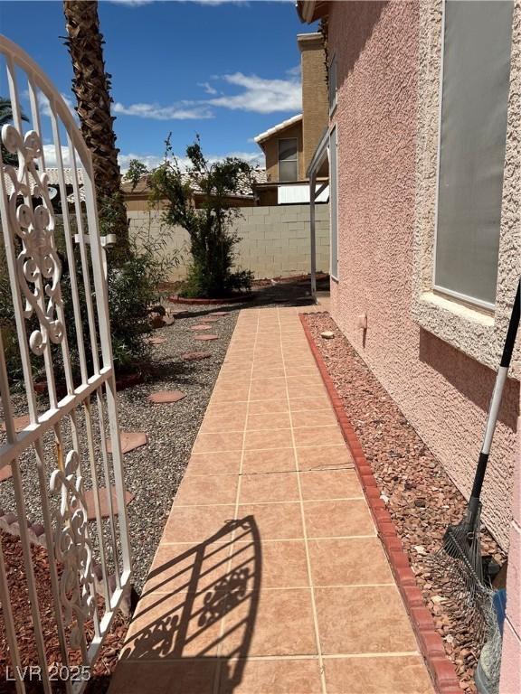 view of yard featuring fence and a gate