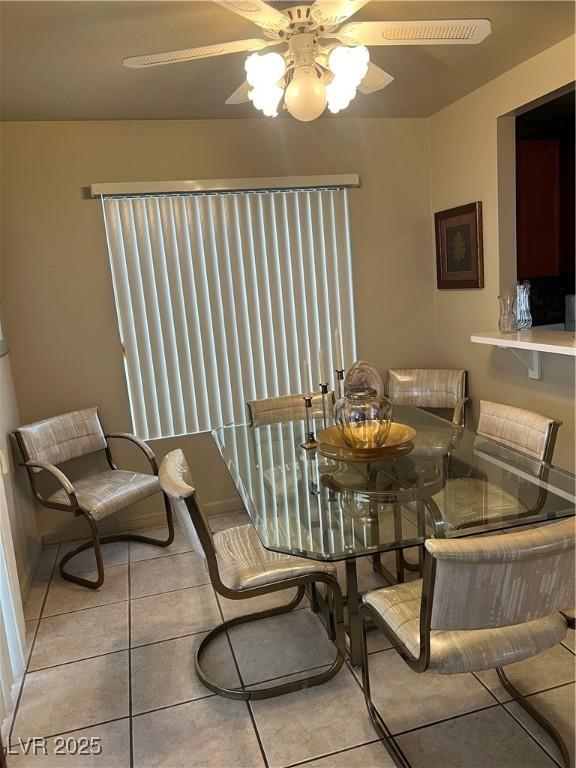 dining space featuring tile patterned flooring and ceiling fan