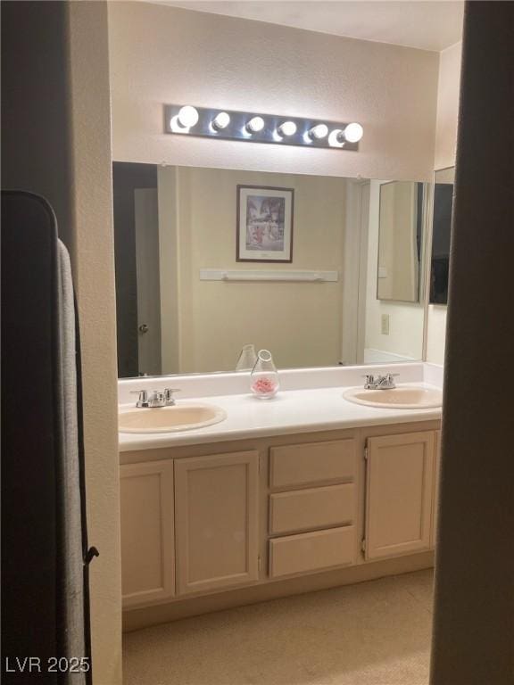 bathroom with a sink and double vanity
