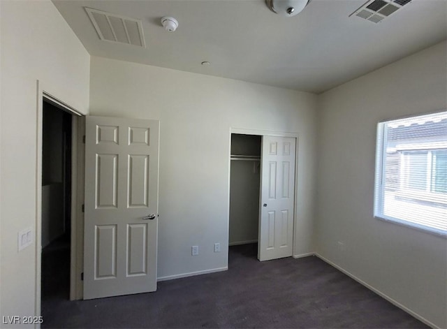 4645 Fuchsia Nights Ave Unit 103, North Las Vegas, NV 89084 - unfurnished bedroom featuring dark carpet and a closet