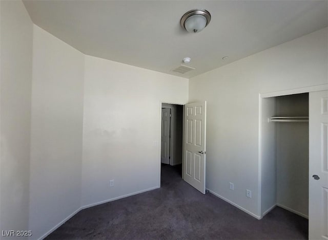 4645 Fuchsia Nights Ave Unit 103, North Las Vegas, NV 89084 - unfurnished bedroom with dark carpet, baseboards, and a closet