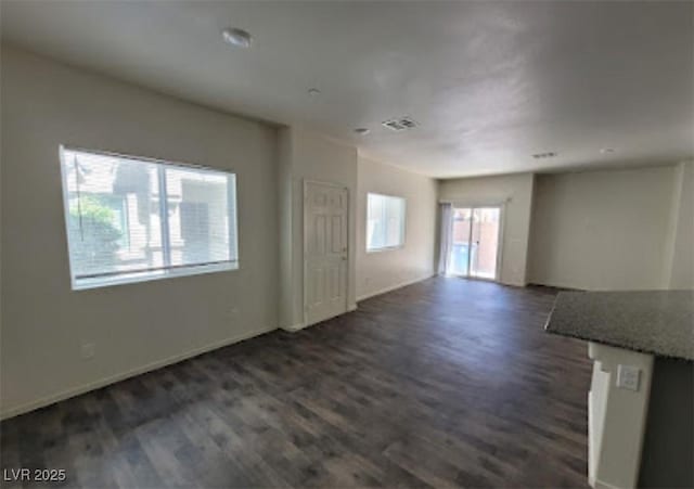 4645 Fuchsia Nights Ave Unit 103, North Las Vegas, NV 89084 - unfurnished living room with dark wood finished floors and baseboards