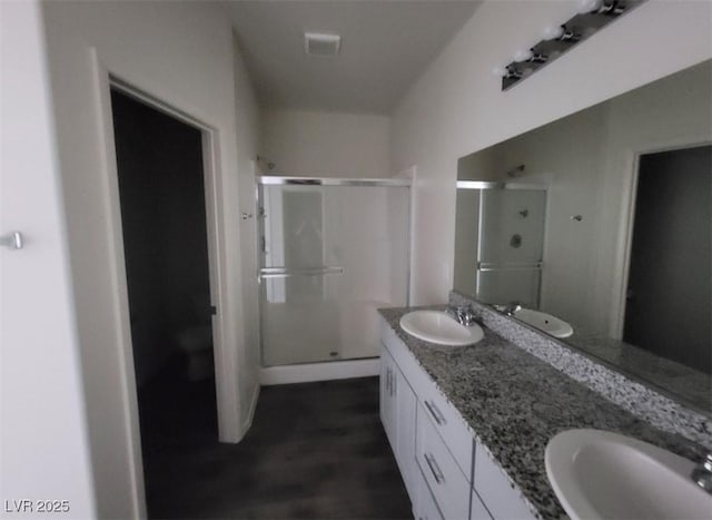 4645 Fuchsia Nights Ave Unit 103, North Las Vegas, NV 89084 - full bathroom with a stall shower, double vanity, and wood finished floors