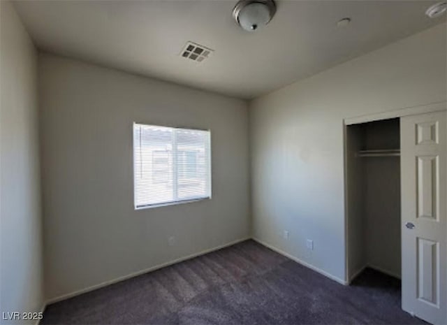 4645 Fuchsia Nights Ave Unit 103, North Las Vegas, NV 89084 - unfurnished bedroom featuring dark colored carpet, a closet, and baseboards