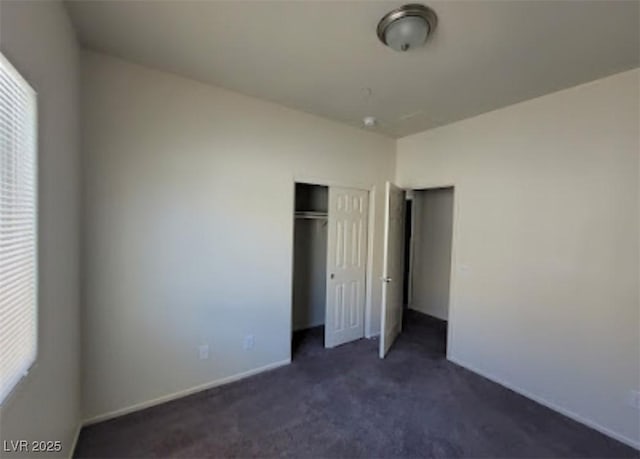 4645 Fuchsia Nights Ave Unit 103, North Las Vegas, NV 89084 - unfurnished bedroom with dark carpet, multiple windows, a closet, and baseboards