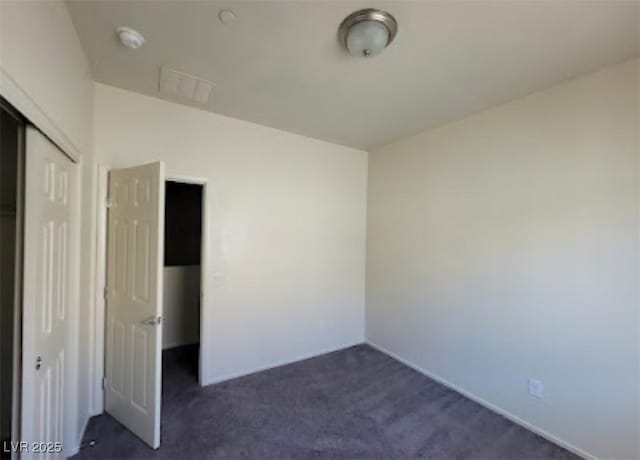 4645 Fuchsia Nights Ave Unit 103, North Las Vegas, NV 89084 - unfurnished bedroom with a closet and dark colored carpet