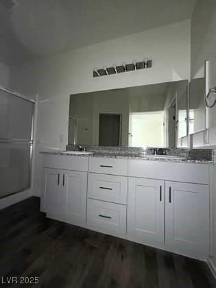 4645 Fuchsia Nights Ave Unit 103, North Las Vegas, NV 89084 - bathroom with double vanity, wood finished floors, and a shower stall