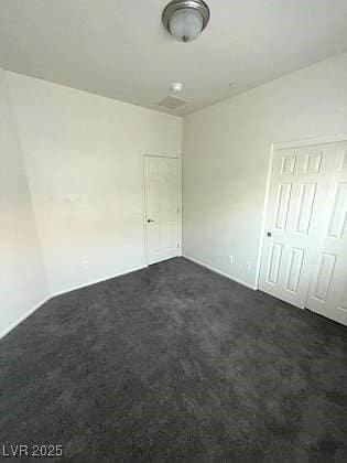 4645 Fuchsia Nights Ave Unit 103, North Las Vegas, NV 89084 - unfurnished bedroom with dark colored carpet and a closet