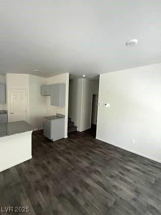 4645 Fuchsia Nights Ave Unit 103, North Las Vegas, NV 89084 - unfurnished living room with stairs and dark wood-style flooring