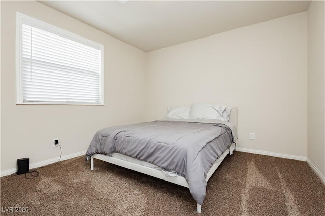carpeted bedroom featuring baseboards