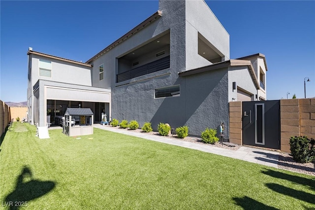 2650 Skylark Trail St, Henderson, NV 89044 - back of house featuring stucco siding and a gate