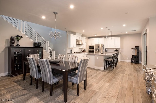 2650 Skylark Trail St, Henderson, NV 89044 - dining area with stairs, light wood-style flooring, recessed lighting, baseboards, and a chandelier