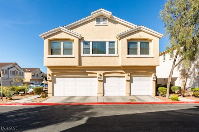 view of front of house featuring concrete driveway, an attached garage, and stucco siding