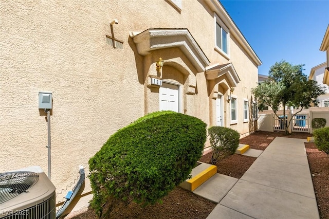 6576 Buster Brown Ave Unit 101, Las Vegas, NV 89122 - doorway to property featuring stucco siding and central AC