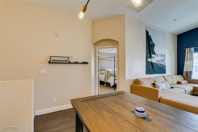 6576 Buster Brown Ave Unit 101, Las Vegas, NV 89122 - dining space with arched walkways, dark wood finished floors, and baseboards