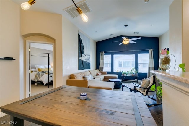 6576 Buster Brown Ave Unit 101, Las Vegas, NV 89122 - dining space with vaulted ceiling, a ceiling fan, wood finished floors, and arched walkways