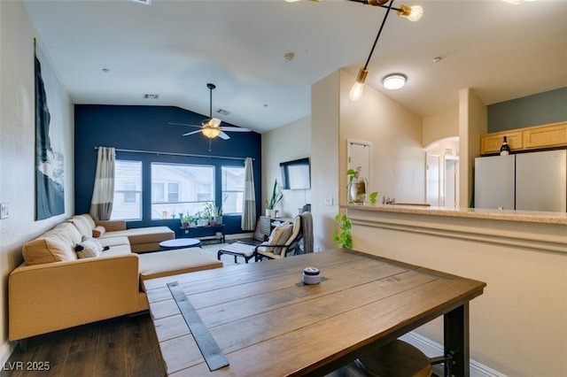 6576 Buster Brown Ave Unit 101, Las Vegas, NV 89122 - dining area with lofted ceiling, dark wood finished floors, ceiling fan, and arched walkways