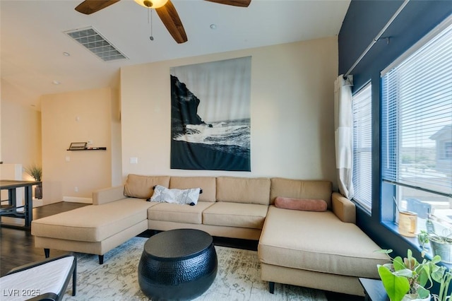 6576 Buster Brown Ave Unit 101, Las Vegas, NV 89122 - living room featuring healthy amount of natural light, a ceiling fan, and wood finished floors