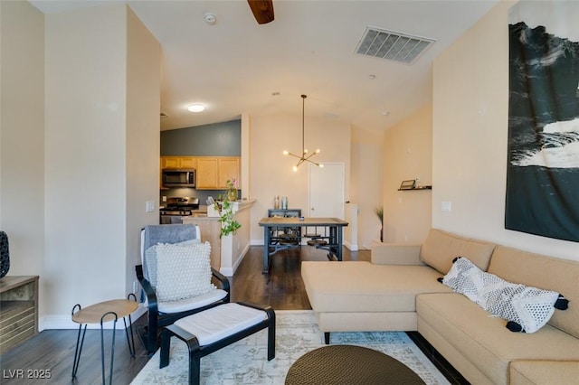 6576 Buster Brown Ave Unit 101, Las Vegas, NV 89122 - living room featuring dark wood-style floors, a chandelier, ceiling fan, baseboards, and high vaulted ceiling