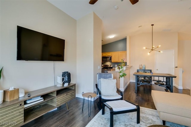 6576 Buster Brown Ave Unit 101, Las Vegas, NV 89122 - living area with ceiling fan, dark wood finished floors, a chandelier, baseboards, and high vaulted ceiling