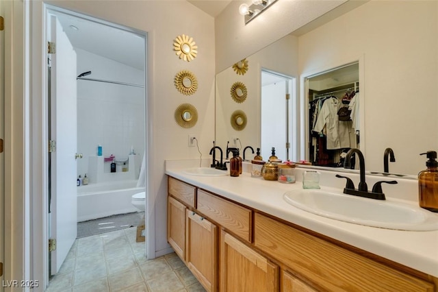 6576 Buster Brown Ave Unit 101, Las Vegas, NV 89122 - full bathroom featuring double vanity, toilet, bathing tub / shower combination, tile patterned flooring, and a spacious closet