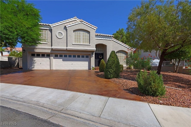 view of front of property featuring a garage, stucco siding, a tiled roof, and driveway
