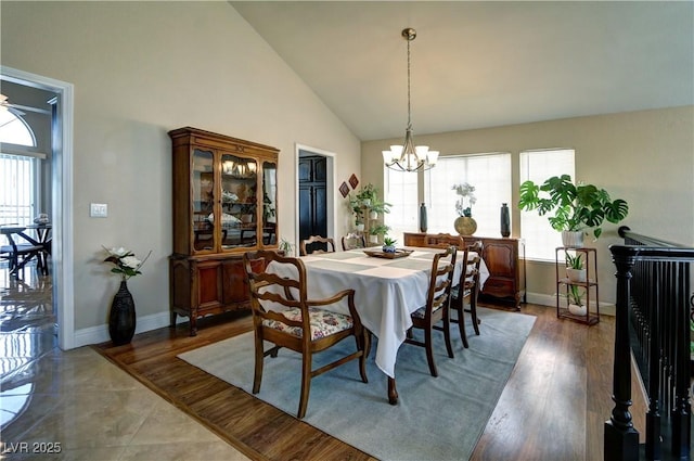dining area with baseboards, plenty of natural light, and a notable chandelier