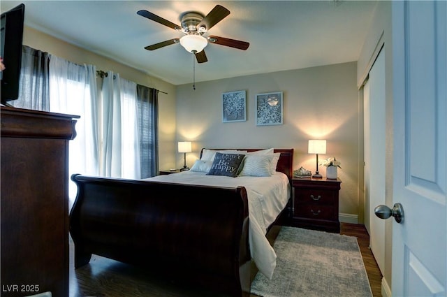 bedroom with baseboards, ceiling fan, and wood finished floors