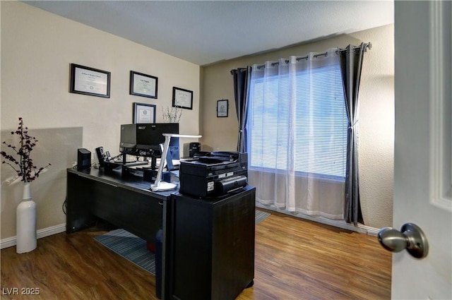 office space featuring baseboards and wood finished floors