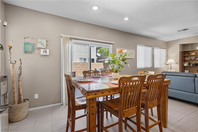 dining area featuring baseboards and recessed lighting
