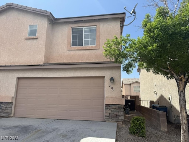 2105 William Holden Ct, Las Vegas, NV 89142 - view of front of property featuring a garage, driveway, stone siding, and stucco siding
