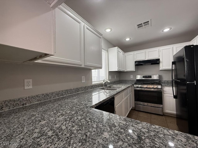 2105 William Holden Ct, Las Vegas, NV 89142 - kitchen featuring visible vents, under cabinet range hood, a sink, dark stone countertops, and black appliances