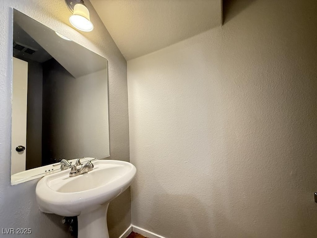 2105 William Holden Ct, Las Vegas, NV 89142 - bathroom featuring visible vents, a sink, and lofted ceiling