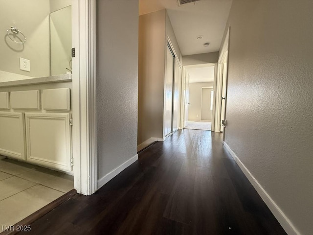 2105 William Holden Ct, Las Vegas, NV 89142 - hallway with baseboards, a textured wall, and dark wood-style floors