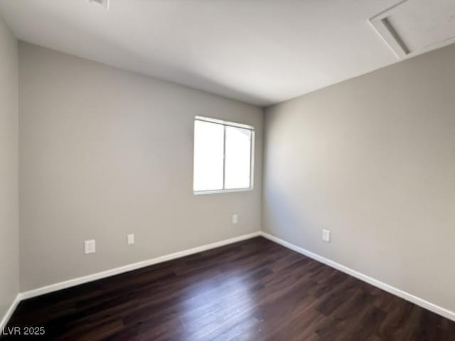 2105 William Holden Ct, Las Vegas, NV 89142 - empty room featuring baseboards, dark wood finished floors, and attic access