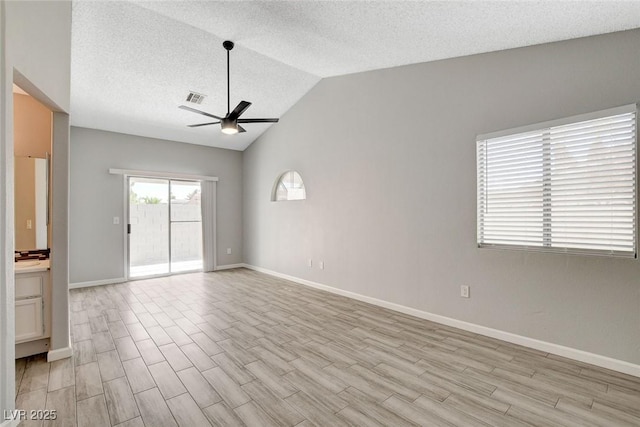 spare room with baseboards, a ceiling fan, light wood-type flooring, and visible vents