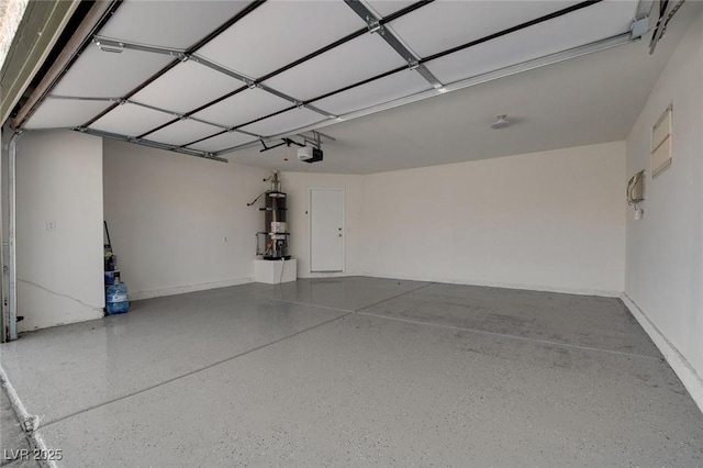 garage with secured water heater and a garage door opener