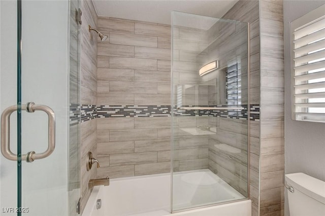 full bath with bath / shower combo with glass door and toilet