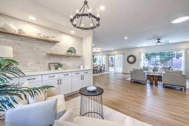 interior space with recessed lighting, light wood-style floors, and ceiling fan with notable chandelier