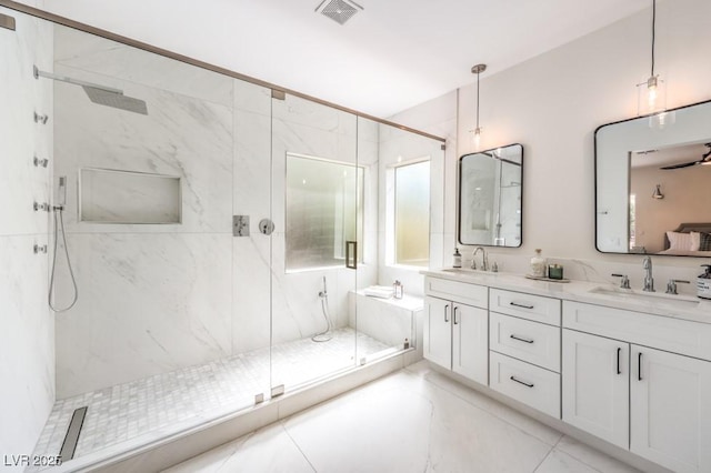 full bath featuring a sink, a marble finish shower, and visible vents