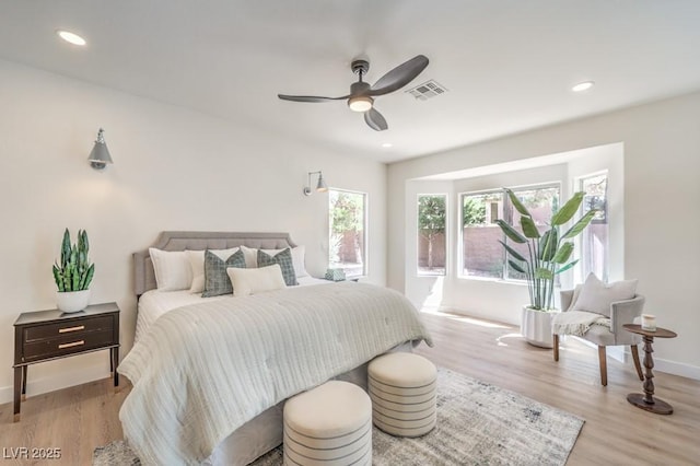 bedroom with baseboards, recessed lighting, light wood-style flooring, and visible vents