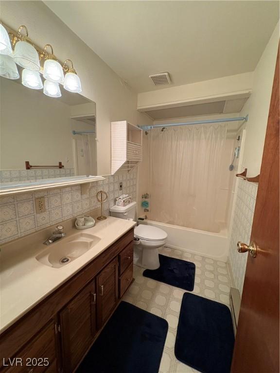 1090E 15th St, Ely, NV 89301 - bathroom with vanity, toilet, shower / bathtub combination with curtain, tasteful backsplash, and visible vents