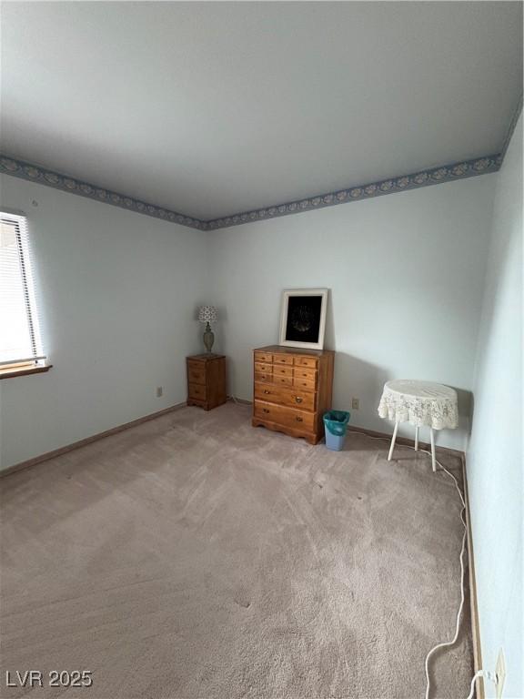 1090E 15th St, Ely, NV 89301 - unfurnished bedroom featuring baseboards and carpet