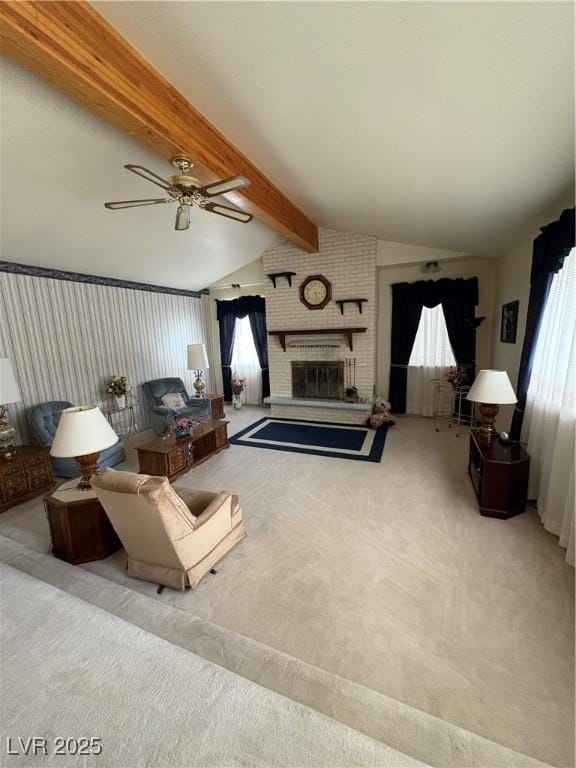 1090E 15th St, Ely, NV 89301 - carpeted living area featuring vaulted ceiling with beams, a ceiling fan, and a fireplace