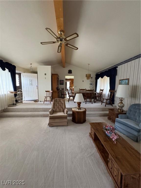 1090E 15th St, Ely, NV 89301 - living area featuring carpet flooring, ceiling fan, lofted ceiling with beams, and plenty of natural light