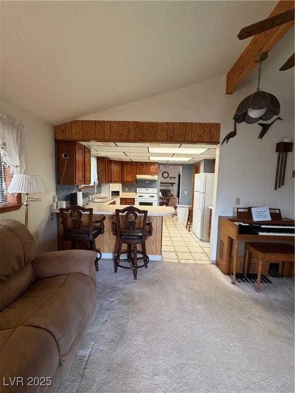 1090E 15th St, Ely, NV 89301 - living area with light colored carpet and lofted ceiling with beams