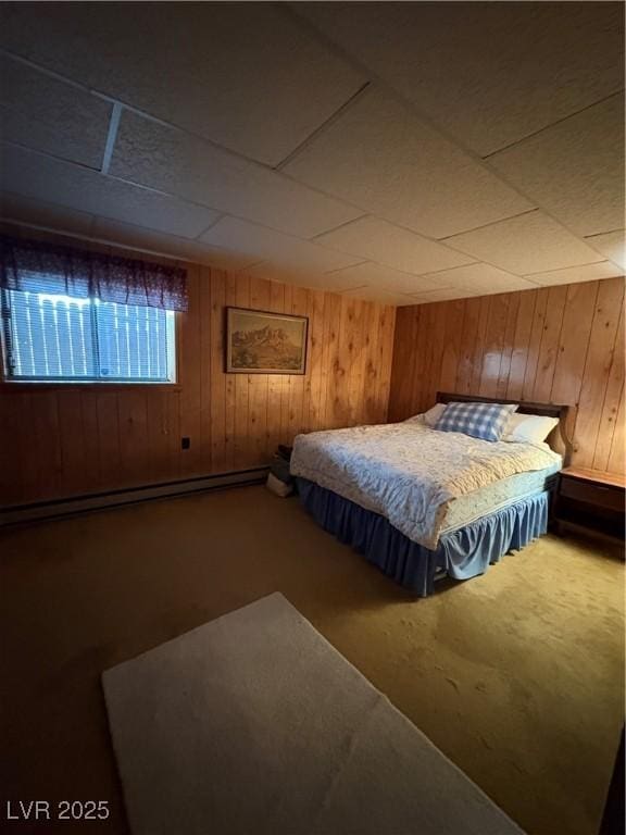 1090E 15th St, Ely, NV 89301 - bedroom with carpet flooring, a baseboard heating unit, and wood walls