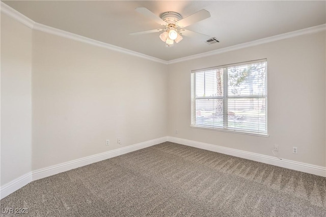 carpeted empty room featuring visible vents, baseboards, crown molding, and ceiling fan