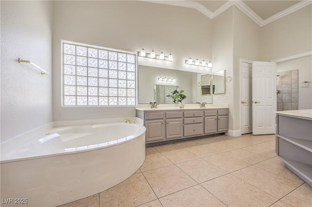 bathroom featuring crown molding, tile patterned flooring, a bath, and double vanity